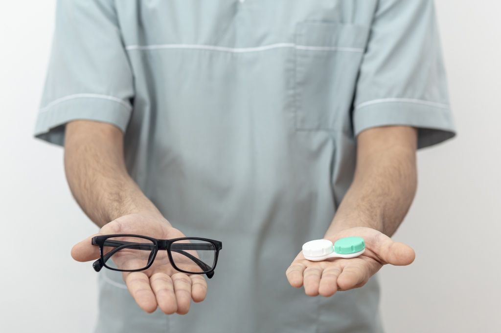 front-view-of-eye-specialist-holding-glasses-and-contact-lenses.jpg